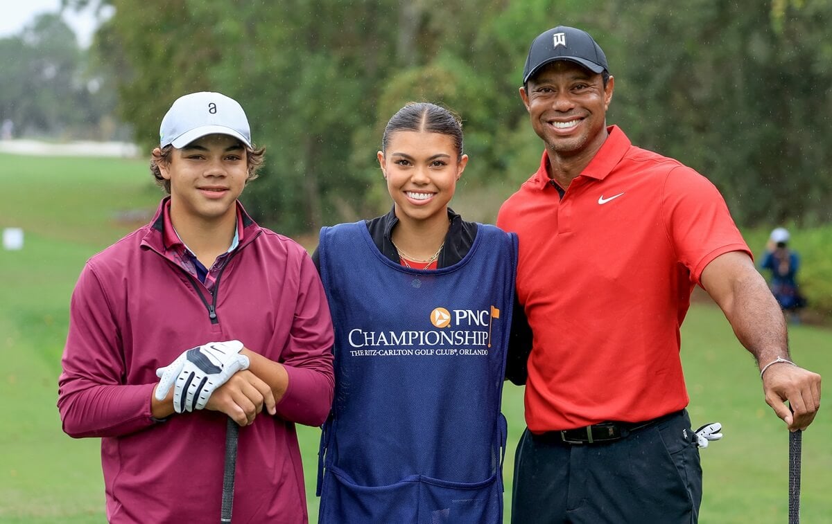 Tiger Woods poses for a picture with his son, Charlie Woods, and his daughter, Sam Woods, who was caddying for her dad during the PNC Championship