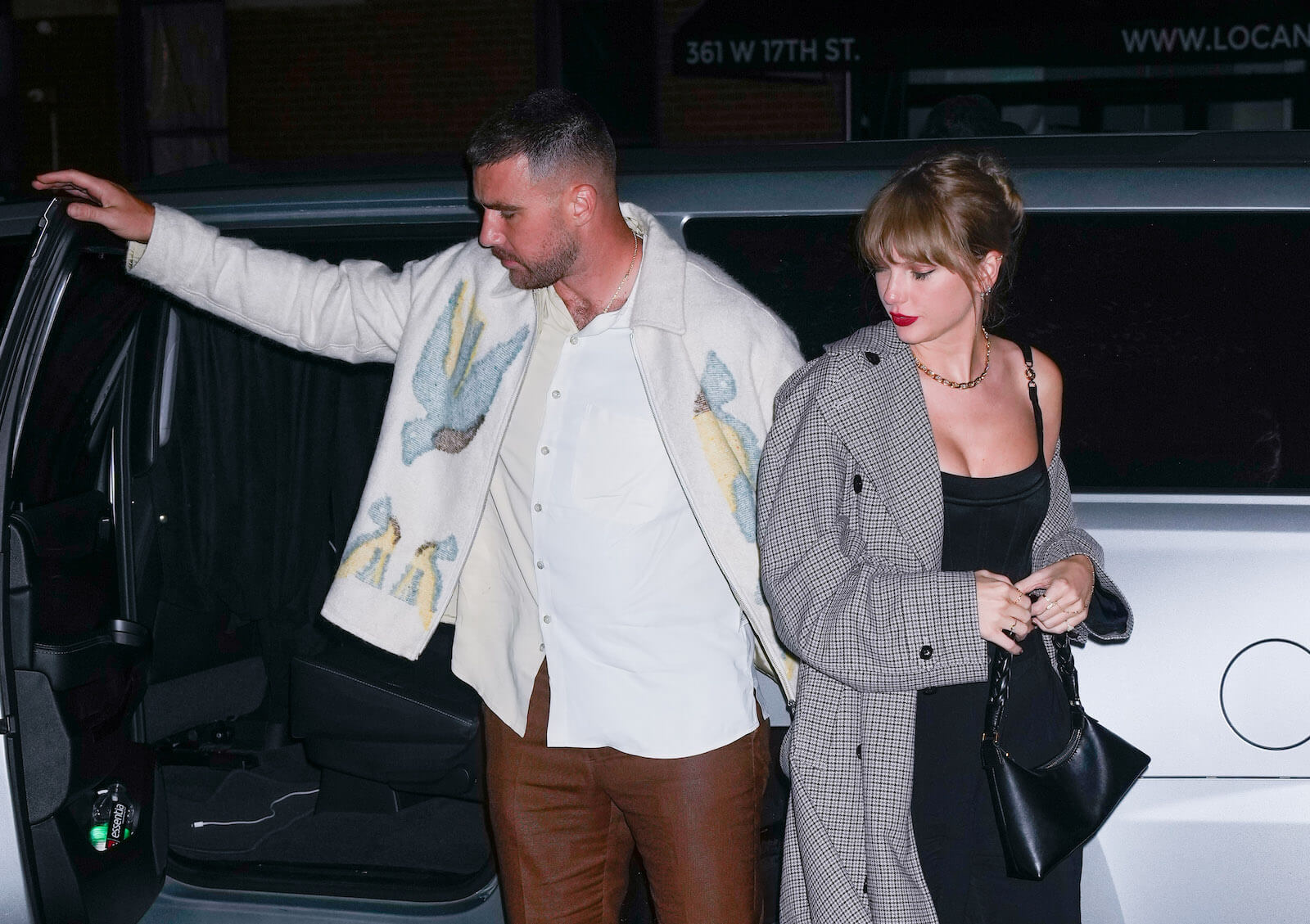 Travis Kelce closing a car door behind Taylor Swift in October 2023