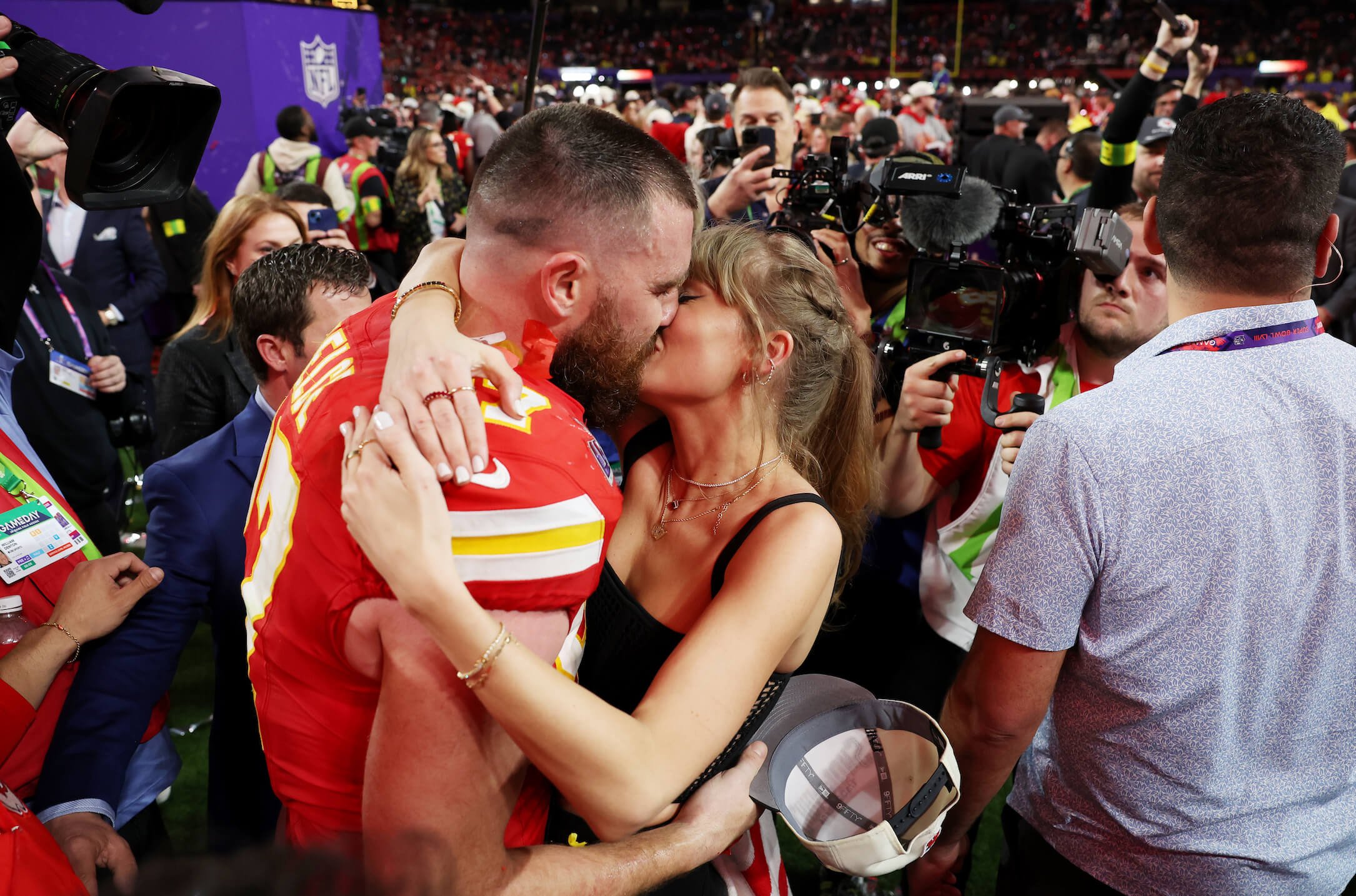 Travis Kelce kissing Taylor Swift after the Super Bowl LVIII