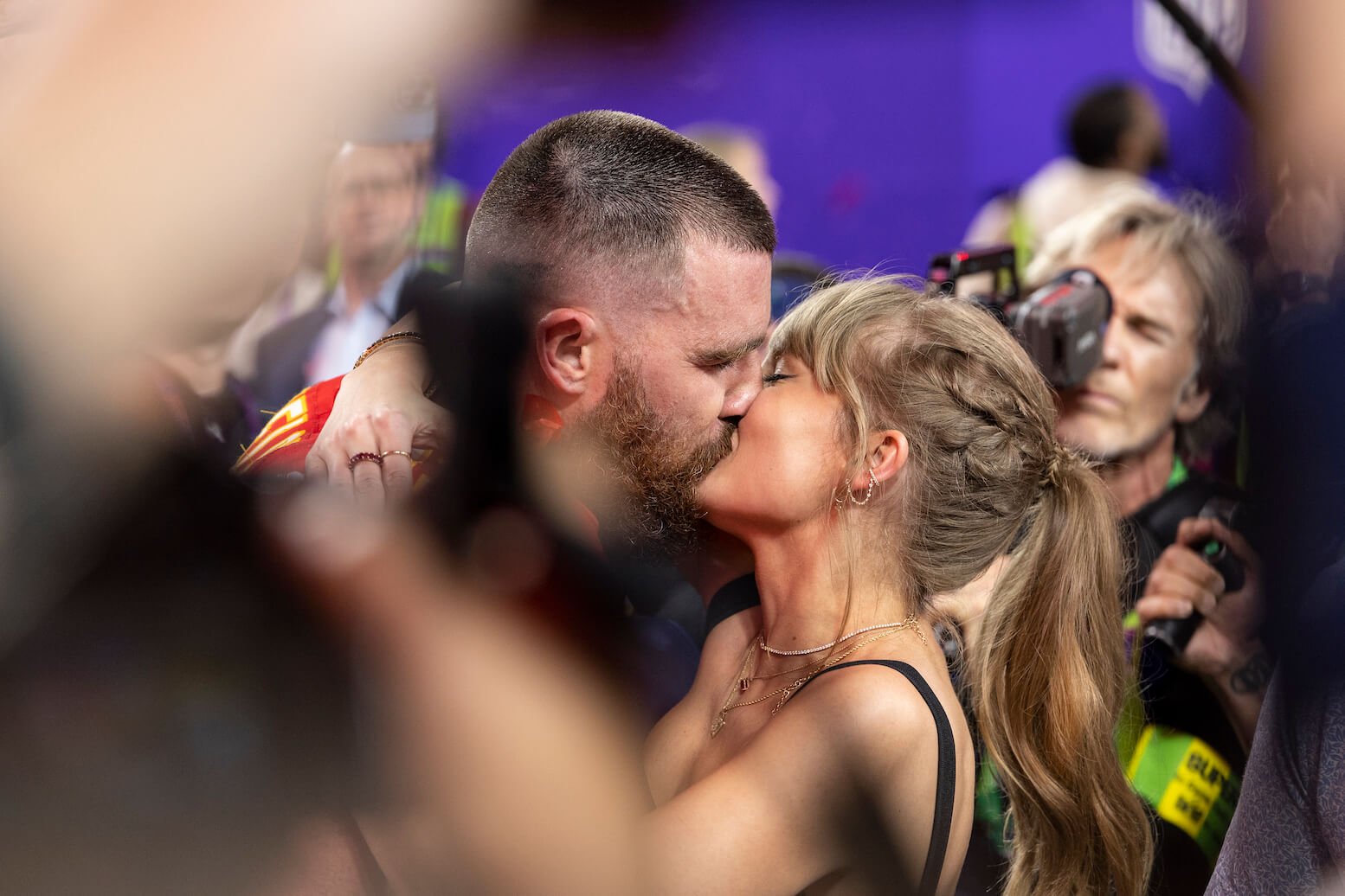 Travis Kelce and Taylor Swift kissing after a Kansas City Chiefs game