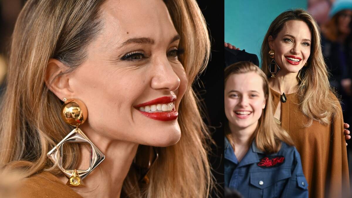 Actor Angelina Jolie walks the red carpet in red lipstick and an ochre cape