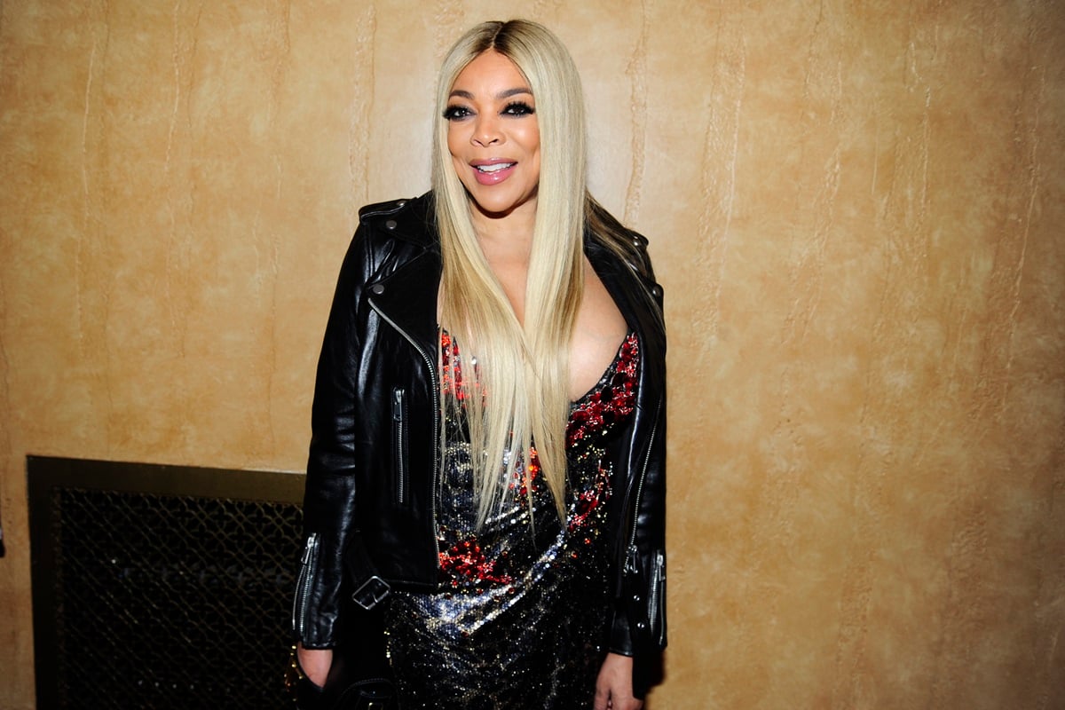 Wendy Williams posing in a black leather jacket and colorful shirt at the Blonds x Moulin Rouge! The Musical.