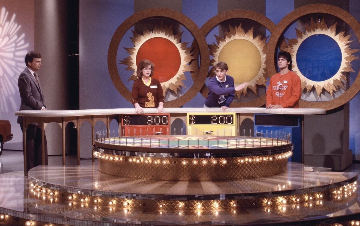 Pat Sajak and contestants on a 1980s episode of 'Wheel of Fortune'