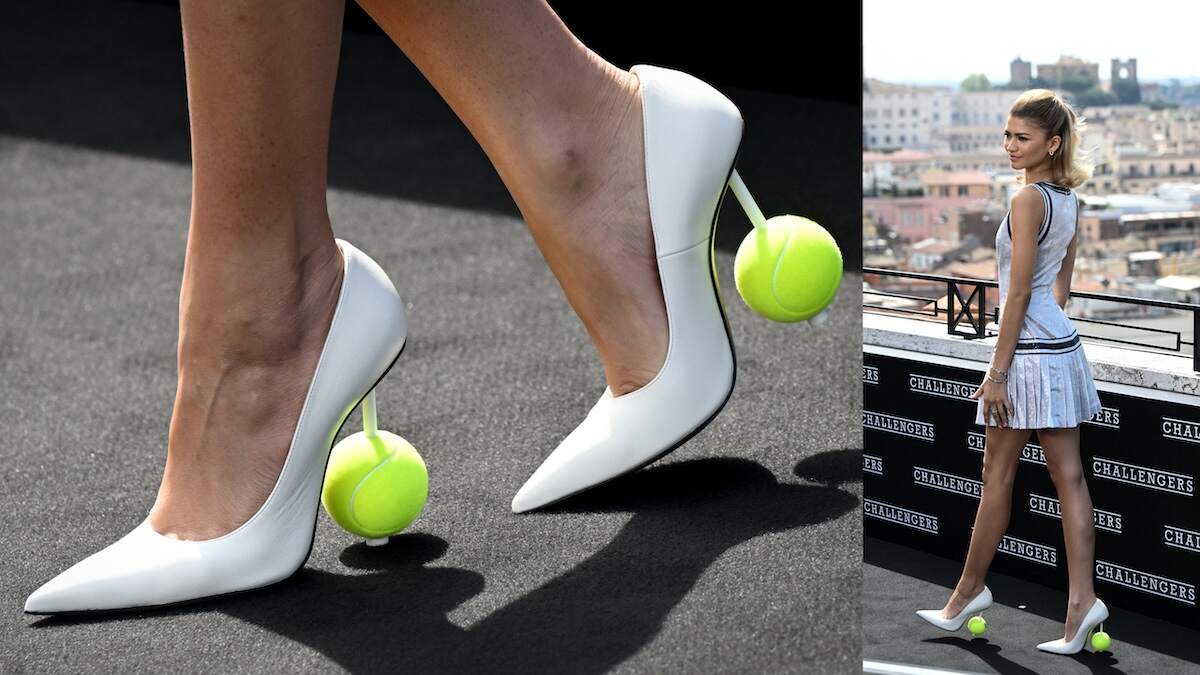 'Challengers' star Zendaya stands and smiles in a white tennis tank top and skirt on a rooftop in Rome, Italy