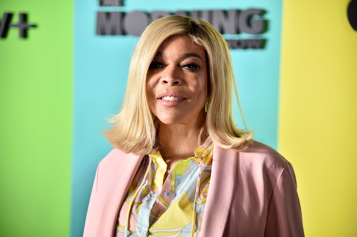 Wendy Williams posing in a pink outfit at the Apple TV+'s "The Morning Show" premiere.