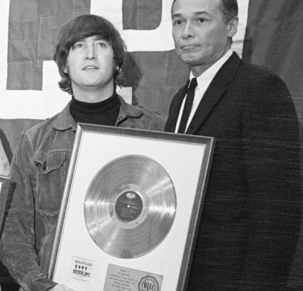 John Lennon standing next to a man