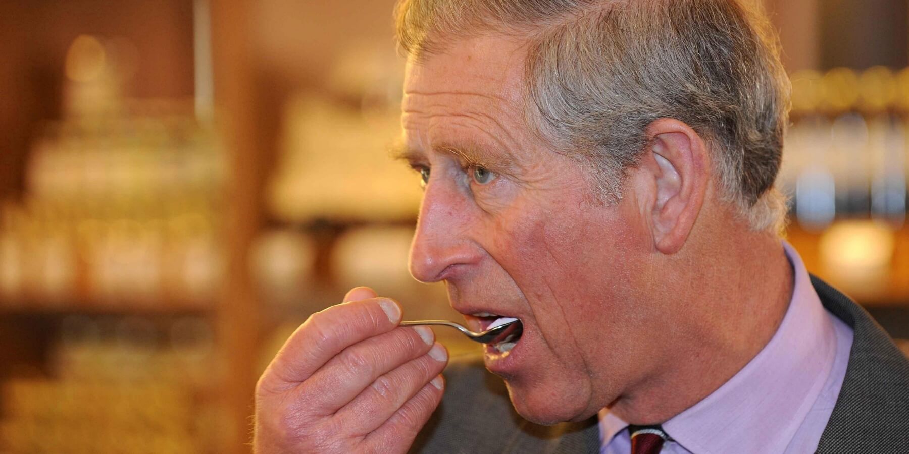 King Charles eating during a royal trip to Booths Supermarket on March 31, 2008 in Kendal, Cumbria, England.