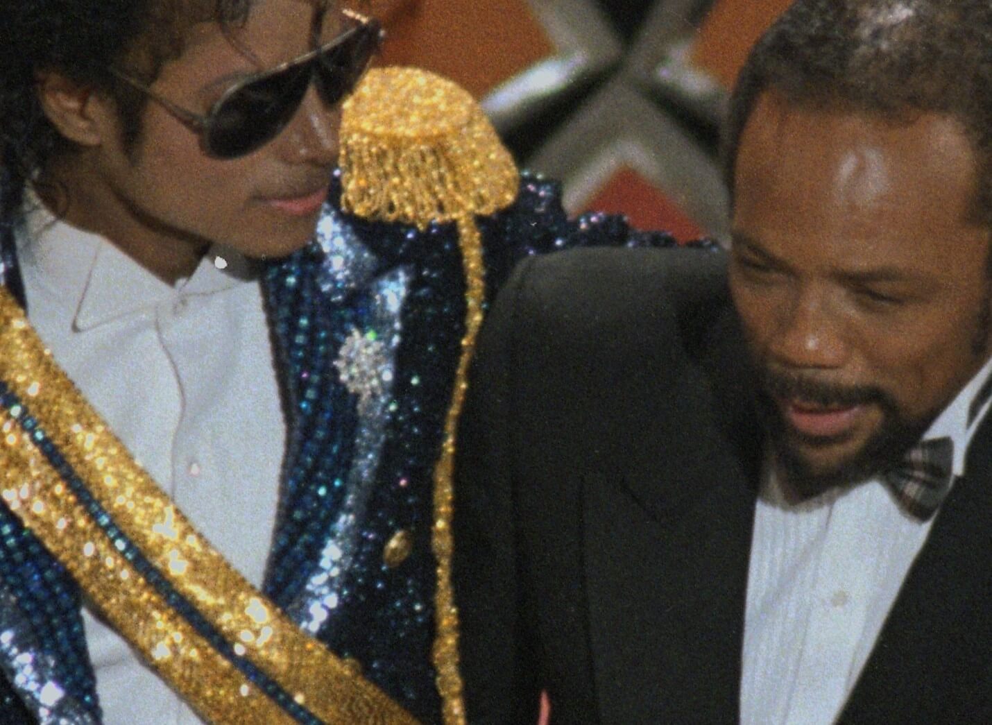 Michael Jackson standing near Quincy Jones