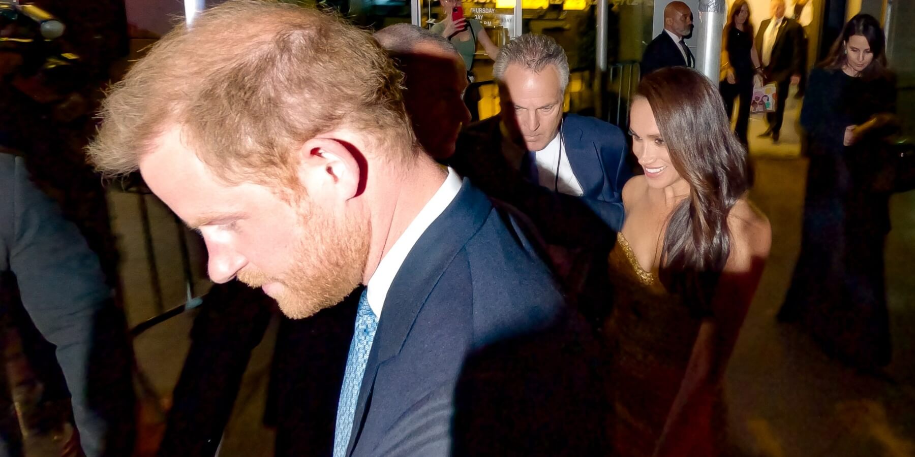 Prince Harry and Meghan Markle surrounded by paparazzi in New York City