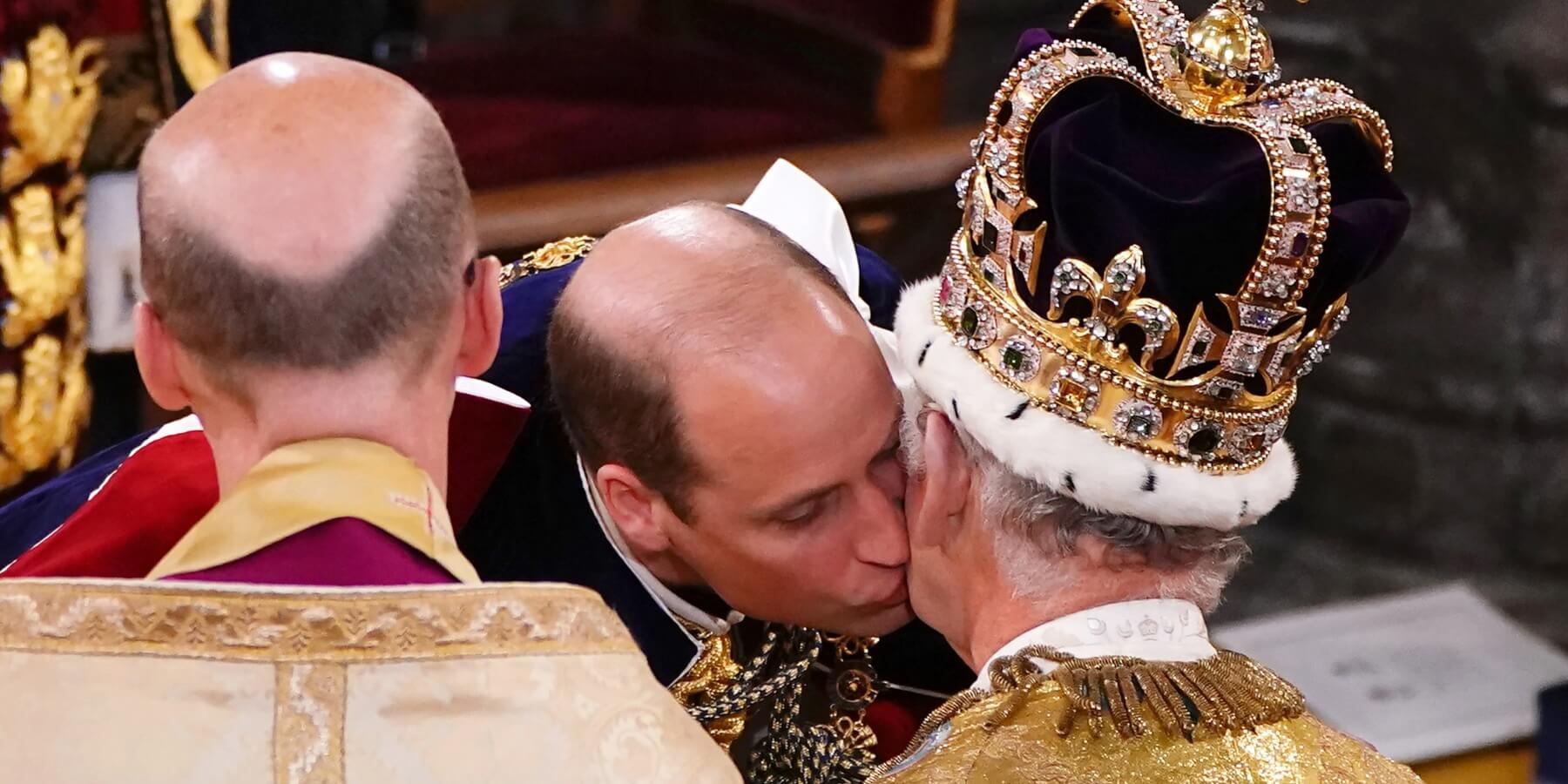 Prince William kisses his father King Charles during his coronation.