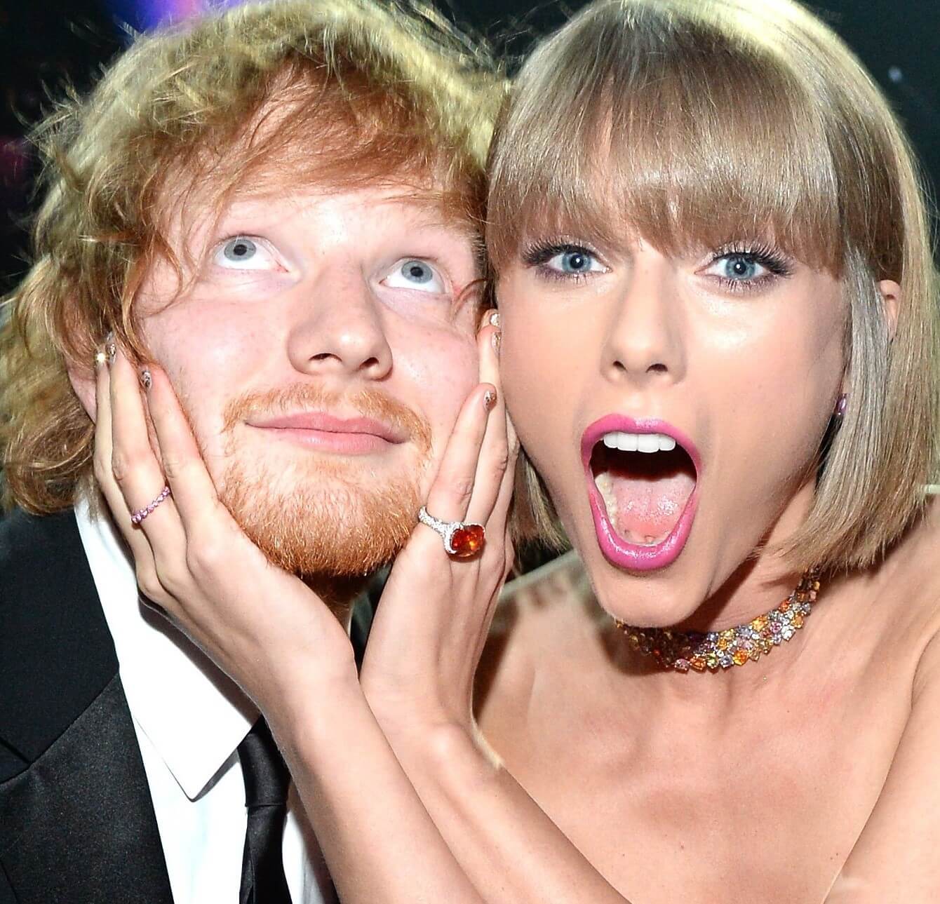 Taylor Swift putting her hands on Ed Sheeran's face