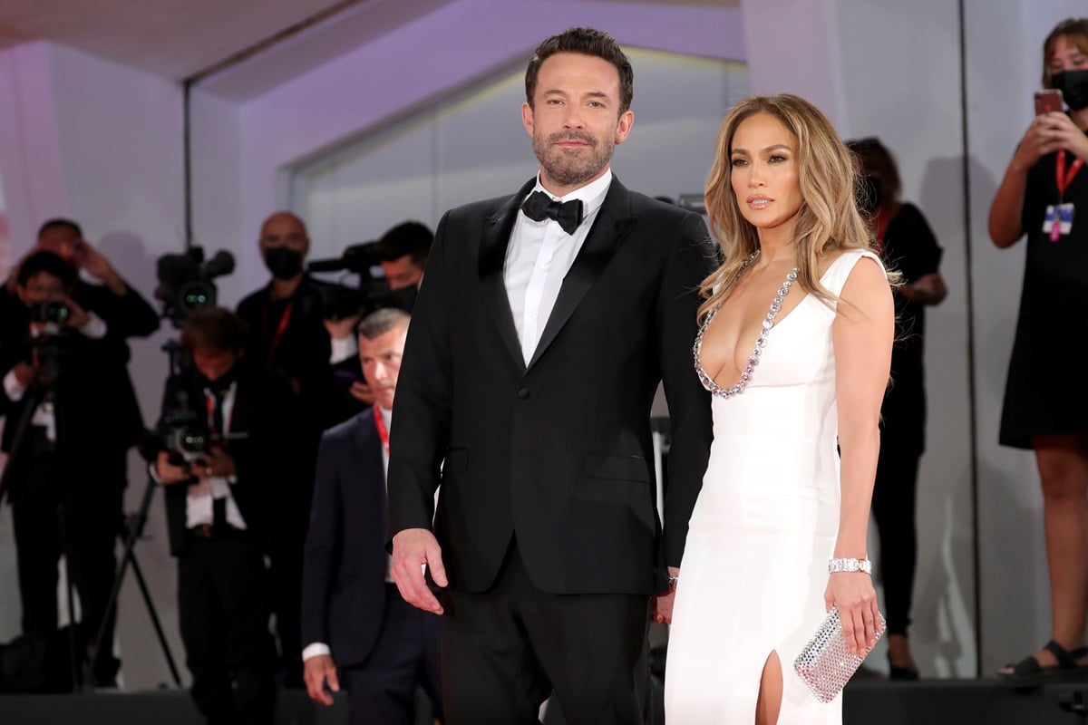 Ben Affleck and Jennifer Lopez posing at the premiere of 'The Last Duel'.