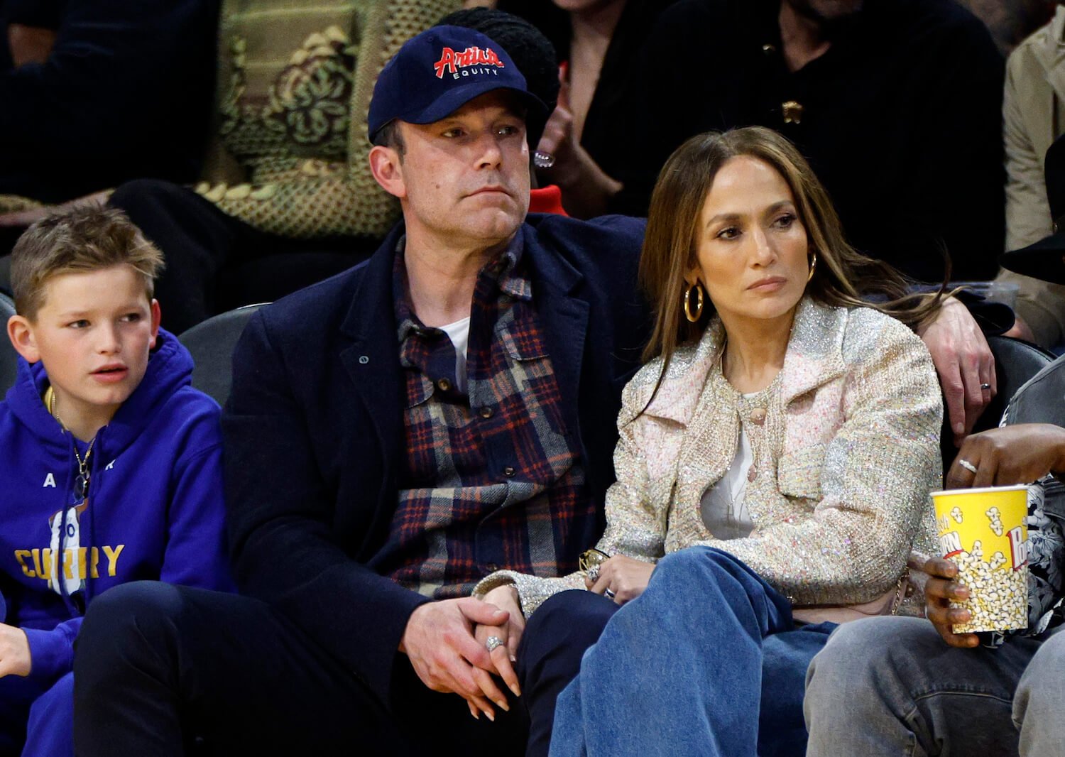 Jennifer Lopez, Ben Affleck, and his son, Samuel Garner Affleck, sitting next to each other at a basketball game