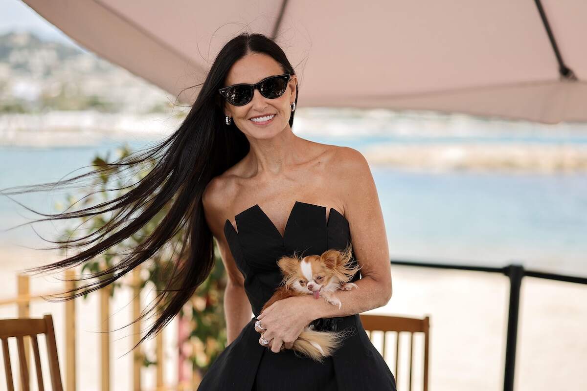 Actor Demi Moore holds her dog Pilaf while speaking at a talk at the 77th annual Cannes Film Festiva