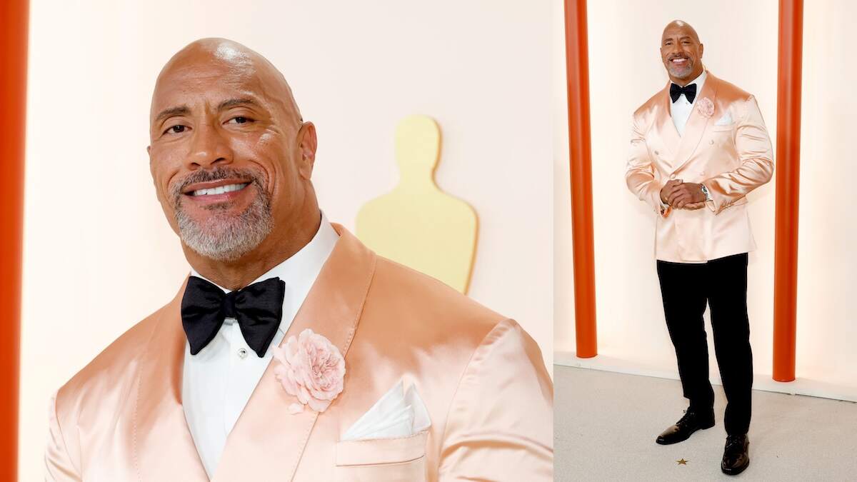 Wearing a pink satin suitcoat, Dwayne Johnson walks the red carpet at the Oscars