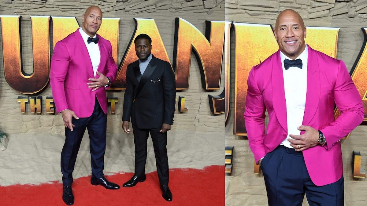 Wearing a hot pink suitcoat, Dwayne Johnson walks the red carpet at the Jumanji premiere
