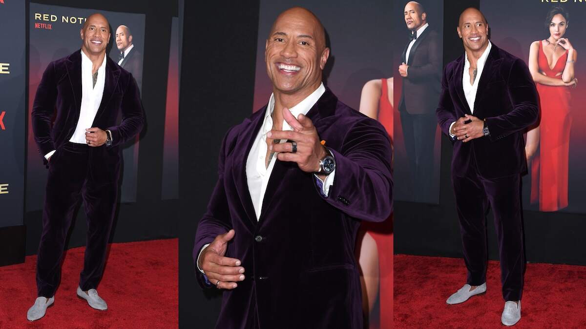Wearing a purple velvet suit, Dwayne Johnson walks the red carpet at the Red Notice premiere