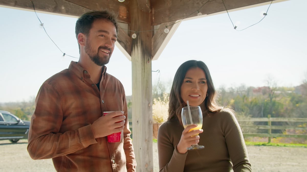 Brandon and Emerson smiling and holding drinks in 'Farmer Wants a Wife' Season 2