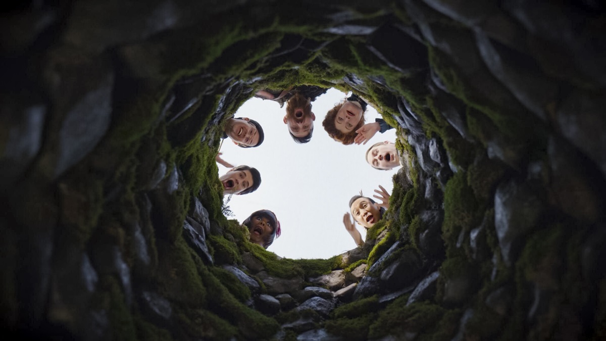 Danielle Pinnock as Alberta, Asher Grodman as Trevor, Richie Moriarty as Pete, Devan Chandler Long as Thorfinn, Rebecca Wisocky as Hetty, Brandon Scott Jones as Isaac, and Roman Zaragoza as Sasappis look into a well during an episode of 'Ghosts'