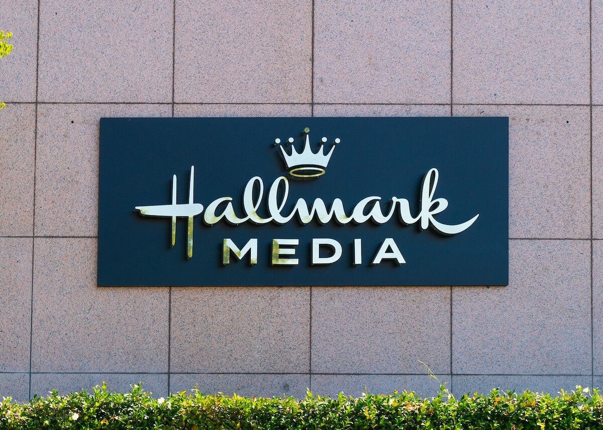 Hallmark Media logo with crown on the side of a building
