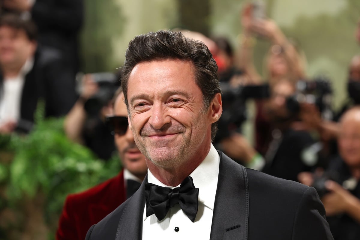 Hugh Jackman posing at the 2024 Met Gala in a suit.