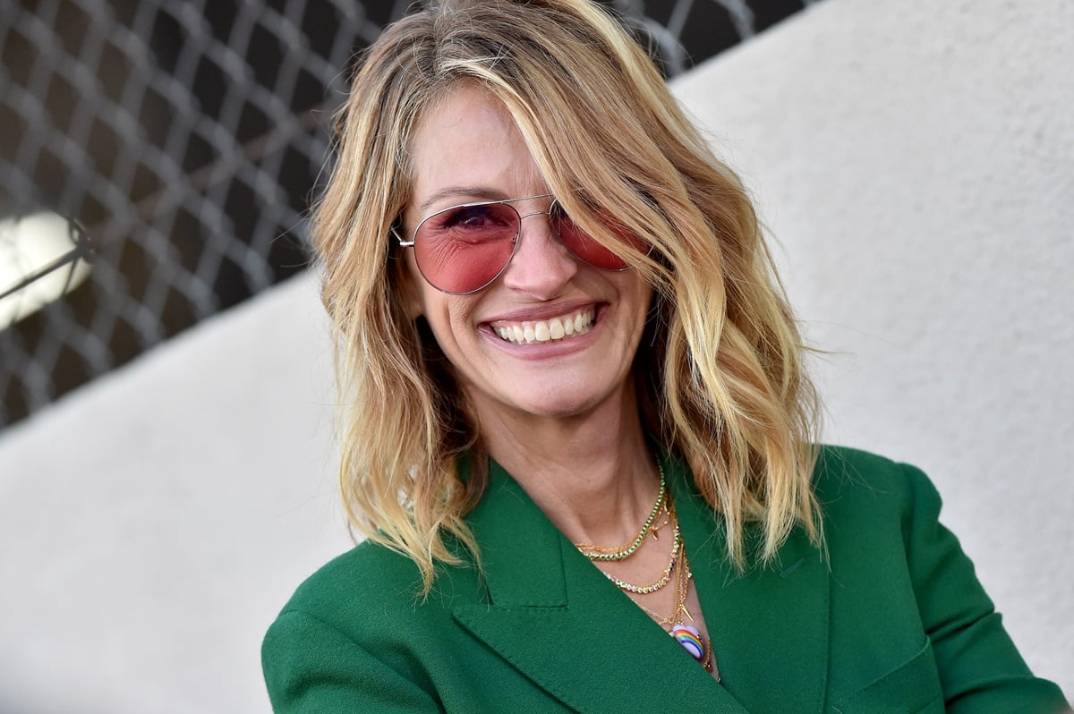 Julia Roberts posing in a green blazer at the Hollywood Walk of Fame.