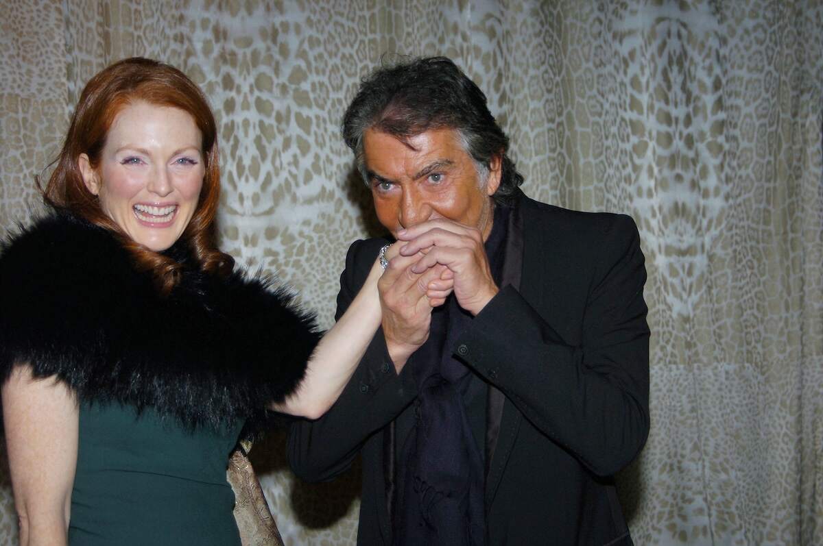 Actor Julianne Moore's hand is kissed by fashion designer Roberto Cavalli at the 2004 Met Gala
