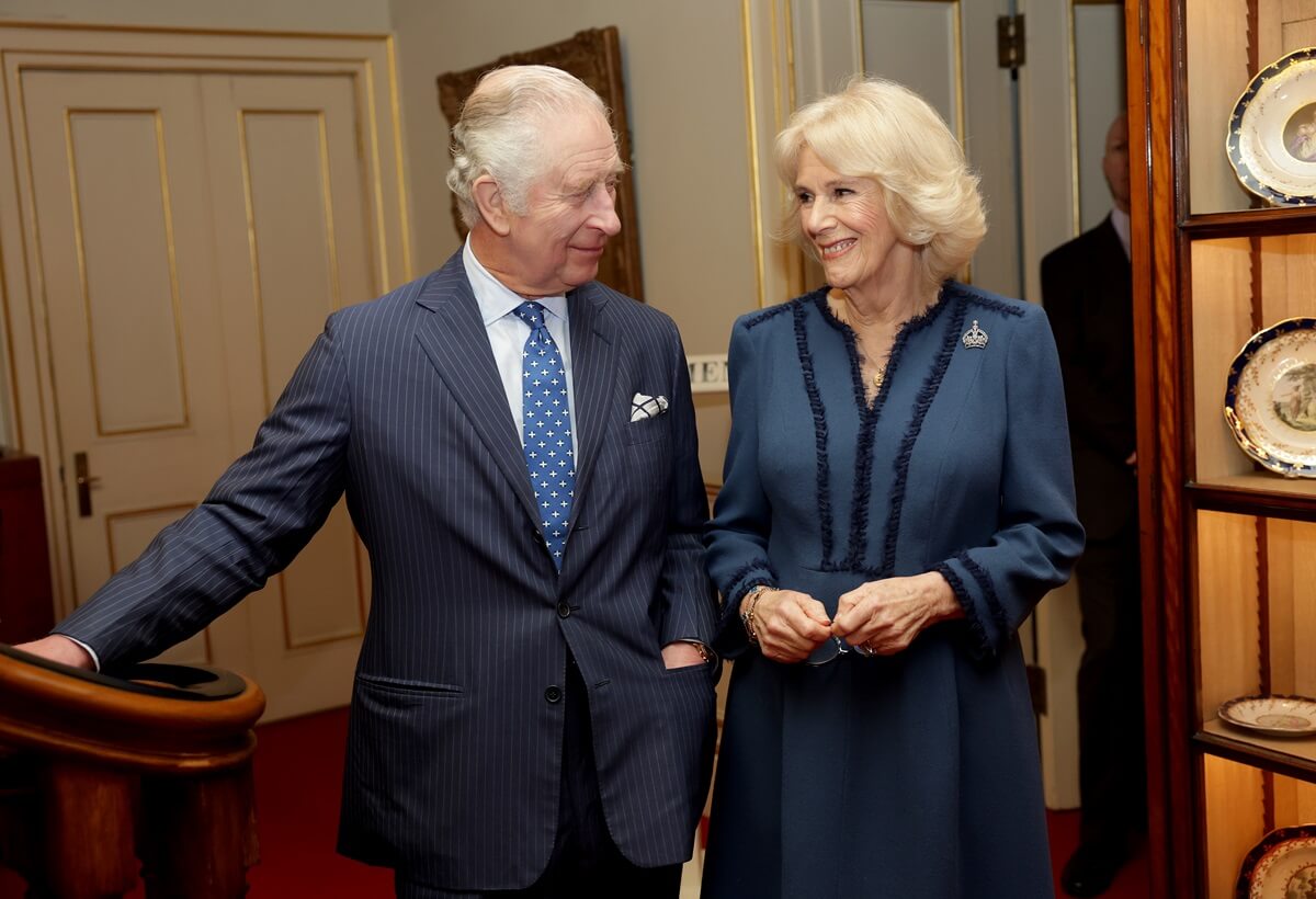  King Charles III and Queen Camilla smile during a reception to celebrate The Reading Room at Clarence House