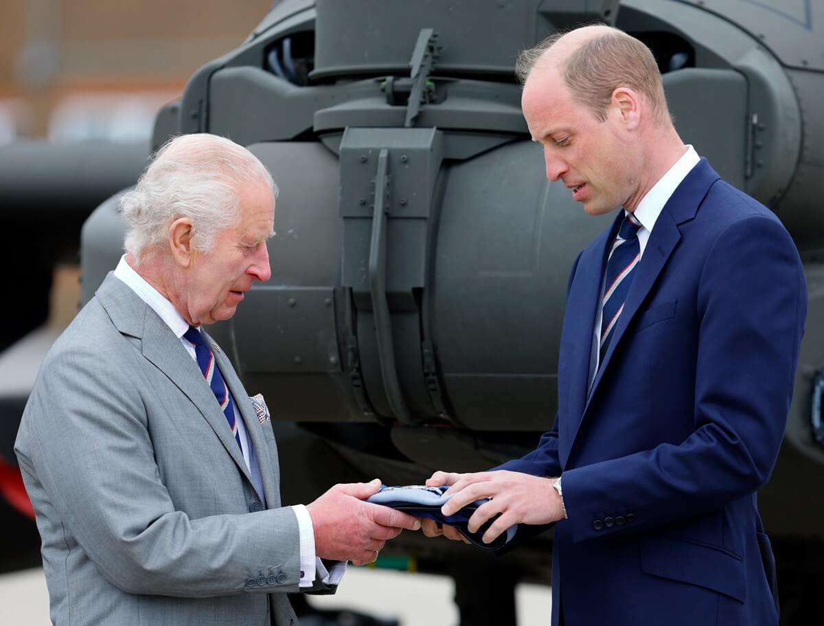 King Charles III presents Prince William with the blue beret and belt of the Army Air Corps during the official handover of the role of Colonel-in-Chief of the Army Air Corps