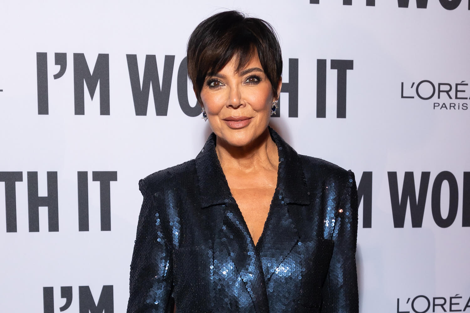 Kris Jenner wearing a metallic blue suit at an event in 2023