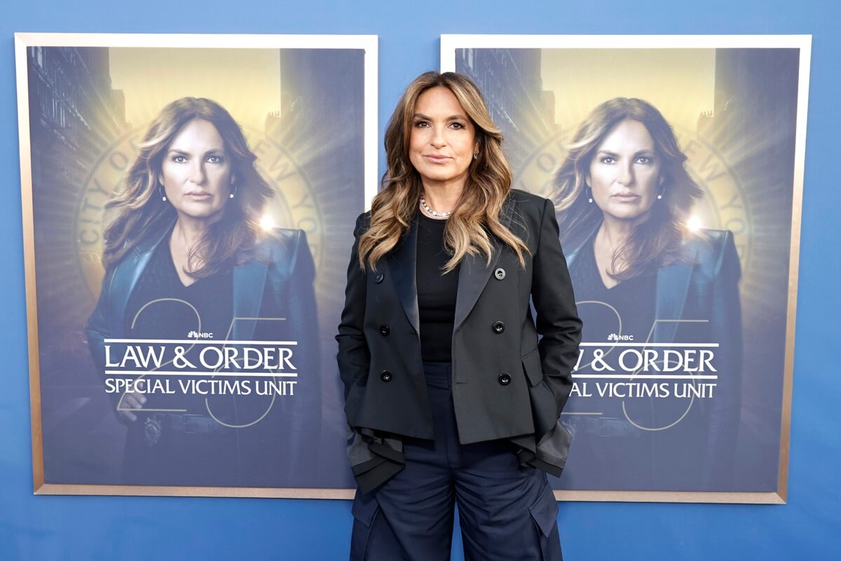 Mariska Hargitay posing in front of a 'Law & Order SVU' poster.