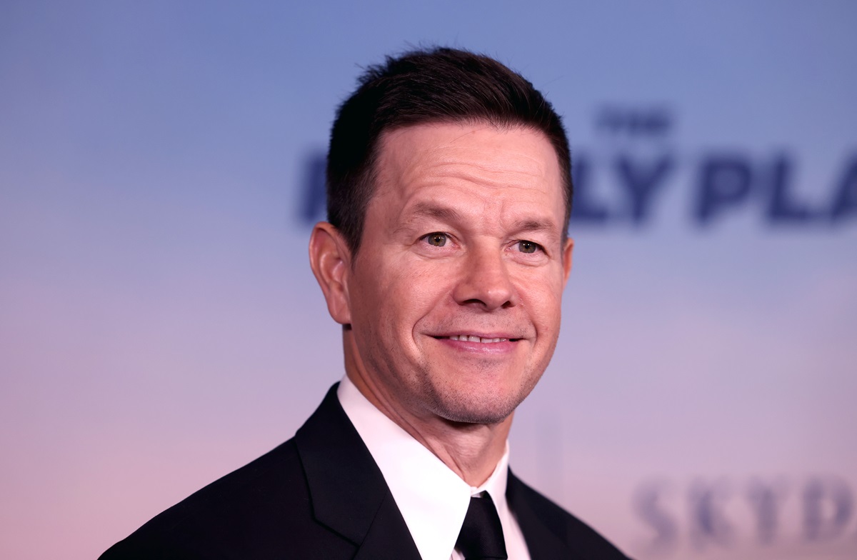 Mark Wahlberg posing in a suit at the premiere of 'The Family Plan'.