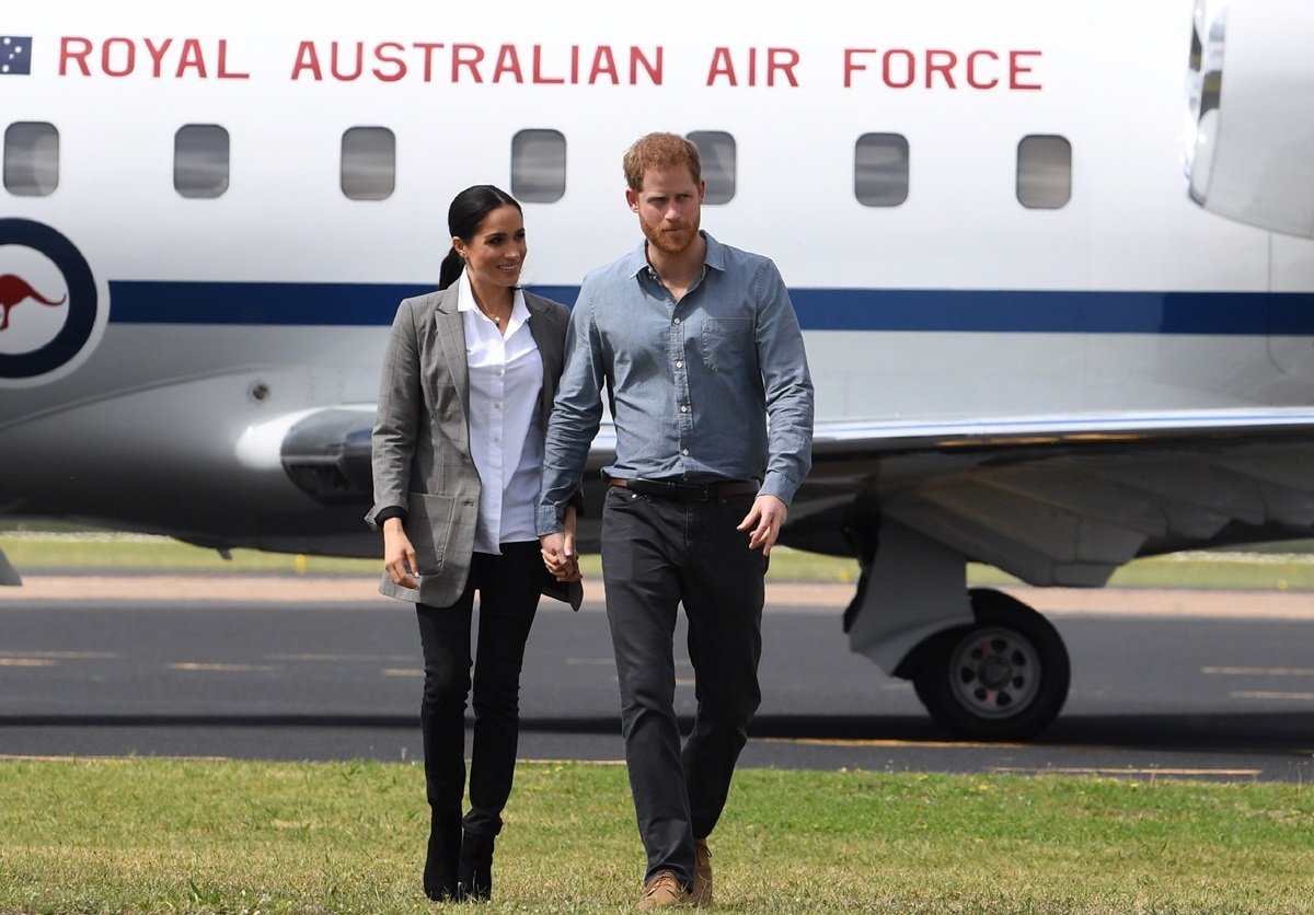 Meghan Markle and Prince Harry exit their plane following their arrival in Dubbo, Australia