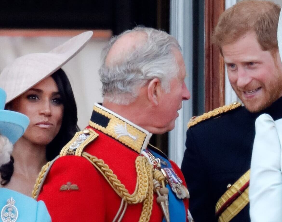 Meghan Markle, now-King Charles III, and Prince Harry standing on the balcony of Buckingham Palace with other royals during Trooping The Colour 2018