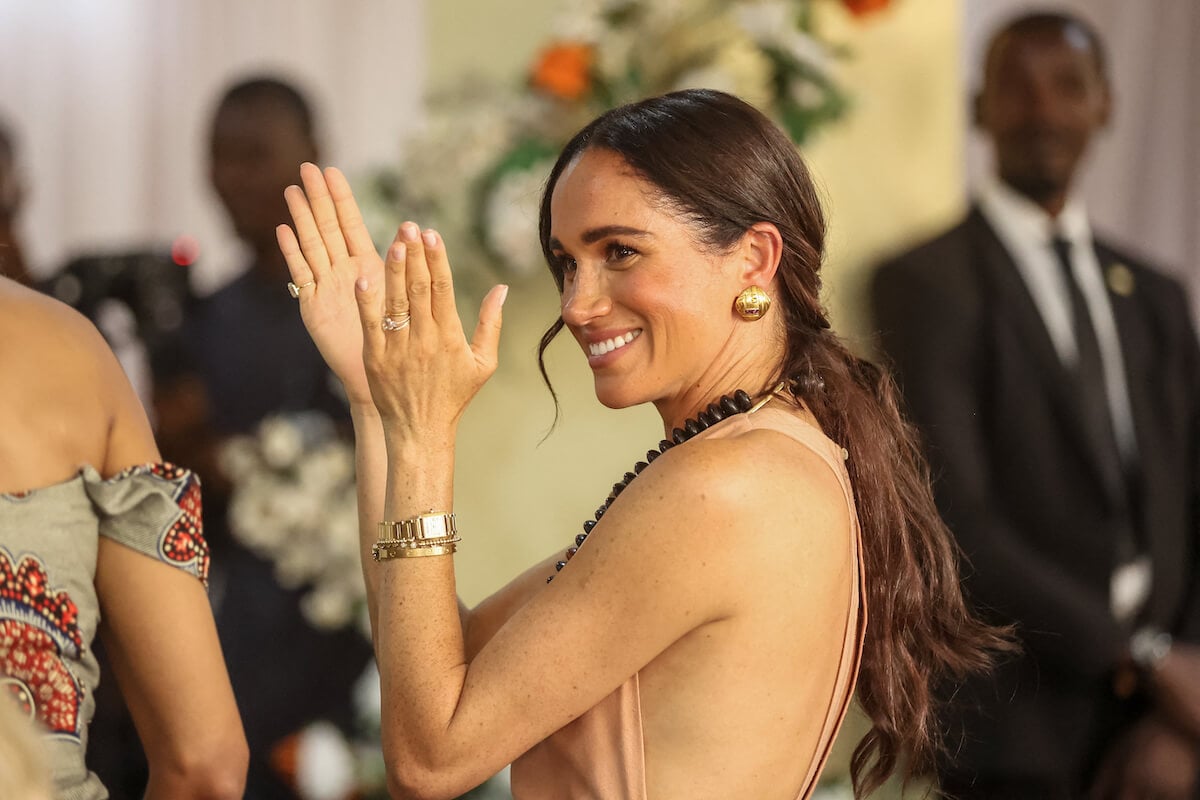 Meghan Markle, who called memories the 'best souvenir' from her and Prince Harry's Nigeria trip, claps and smiles in Nigeria