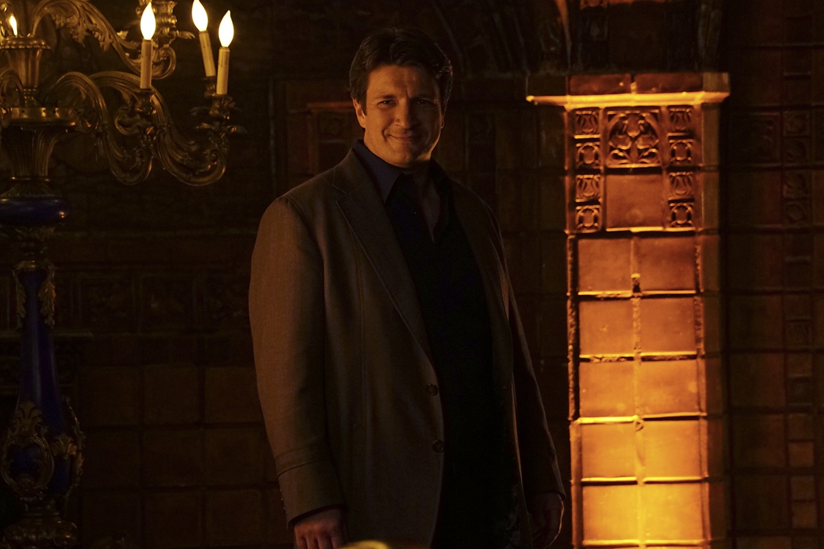 Nathan Fillion posing in a suit in a season 8 episode of 'Castle'.