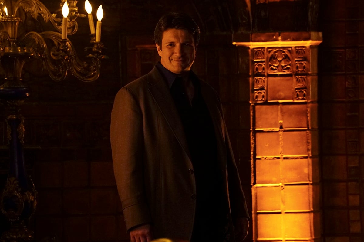 Nathan Fillion posing in a suit in a season 8 episode of 'Castle'.