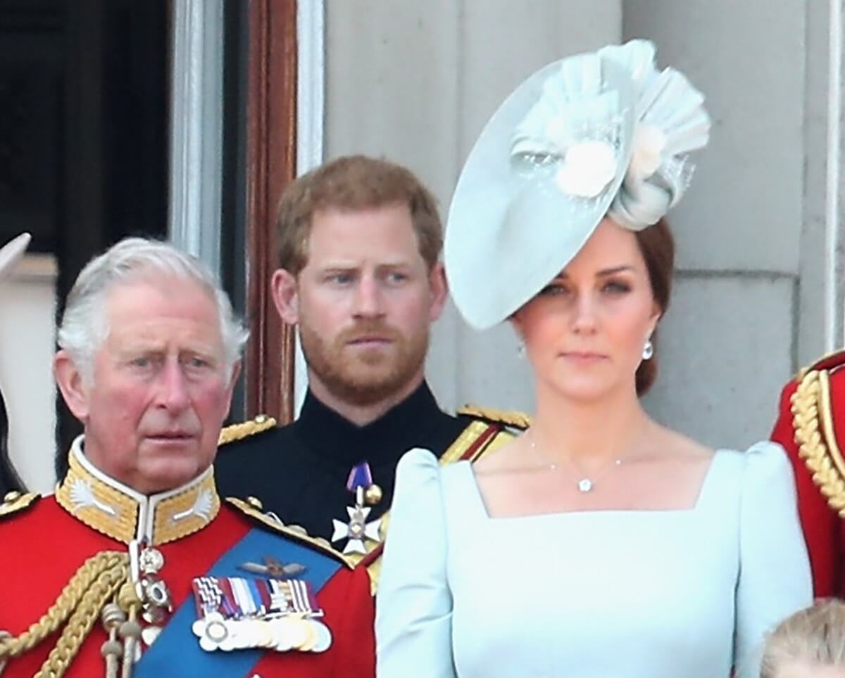 Now-King Charles III, Prince Harry, and Kate Middleton standing on the balcony of Buckingham Palace during Trooping The Colour 2018