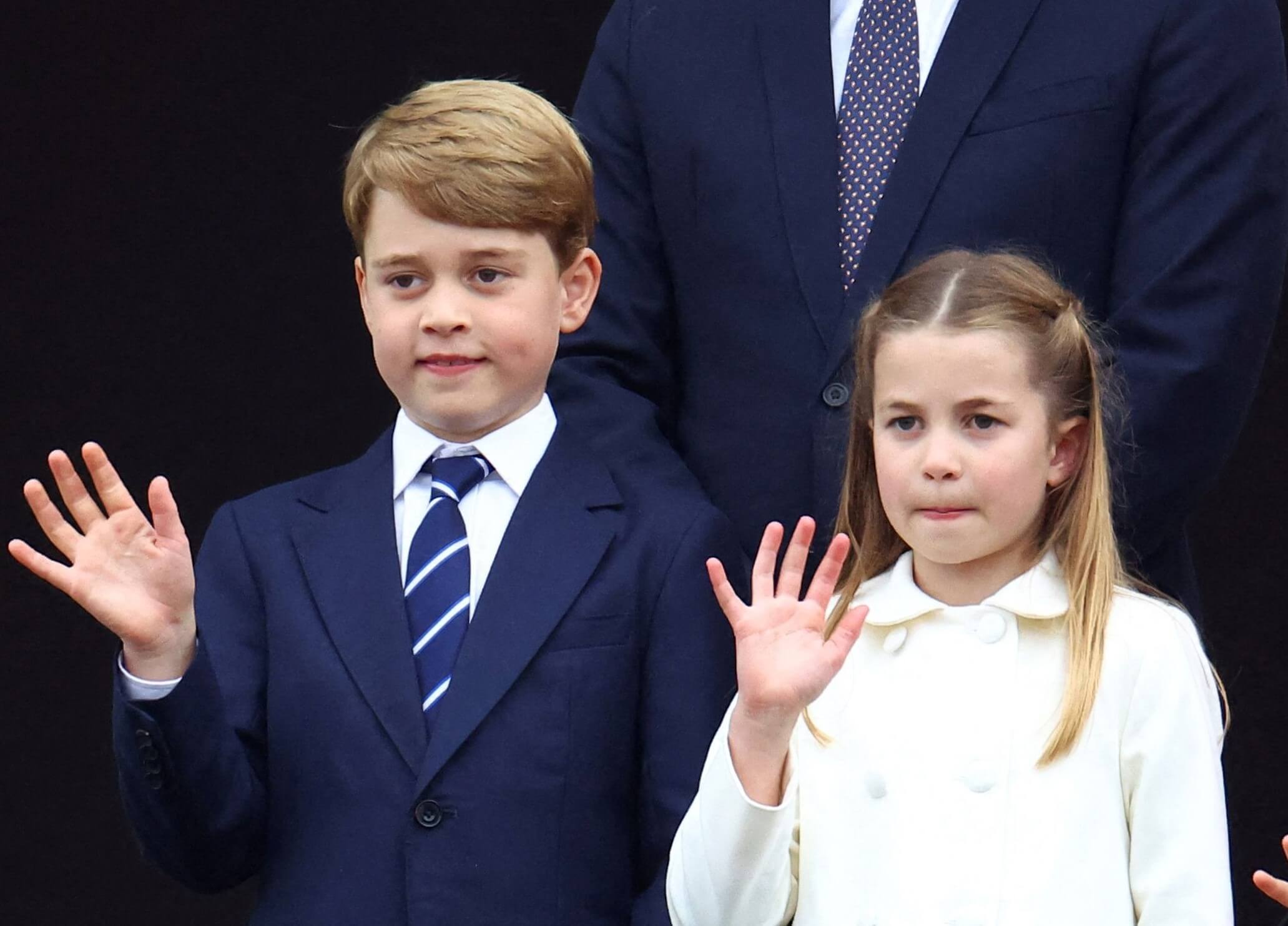 Prince George and Princess Charlotte waving from the balcony of Buckingham Palace at the end of the Platinum Pageant