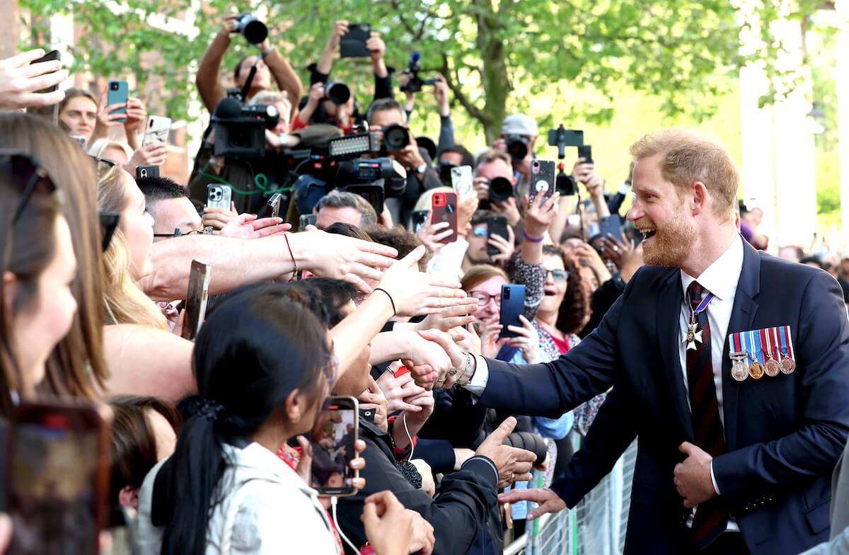 Prince Harry greets fans outside of his Invictus Games ceremony