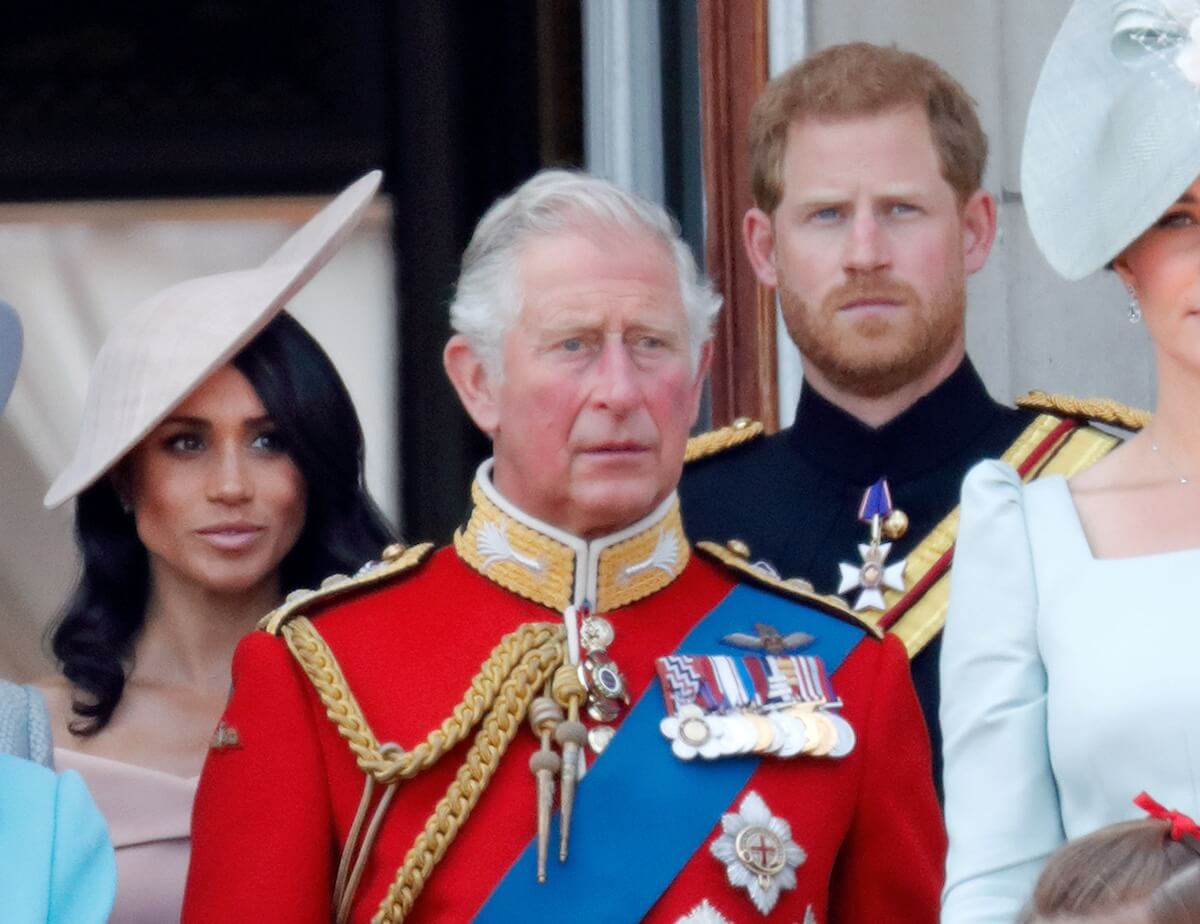 Meghan Markle and Prince Harry stand behind King Charles at Trooping the Colour in 2018