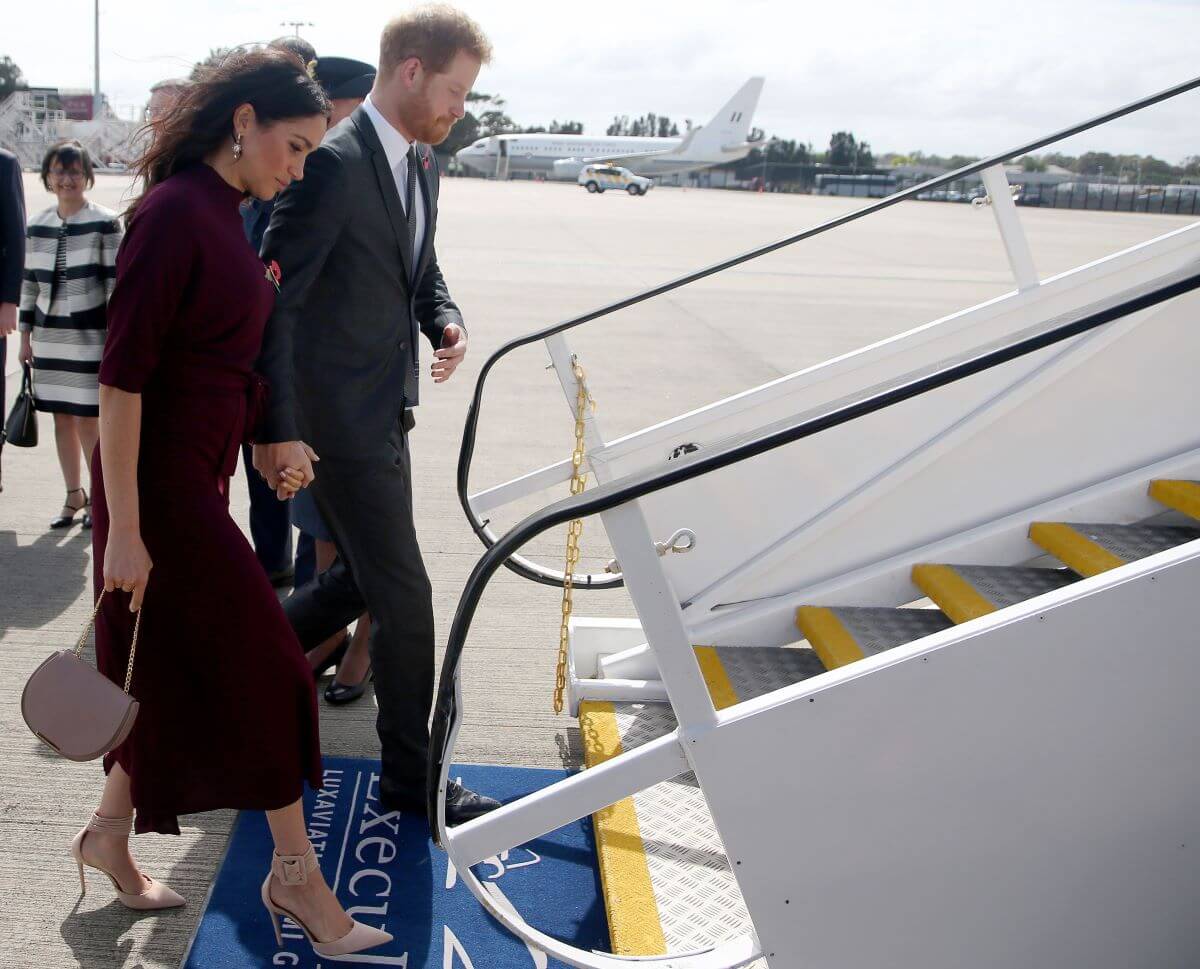 Prince Harry and Meghan Markle board a plane for New Zealand from Sydney airport 