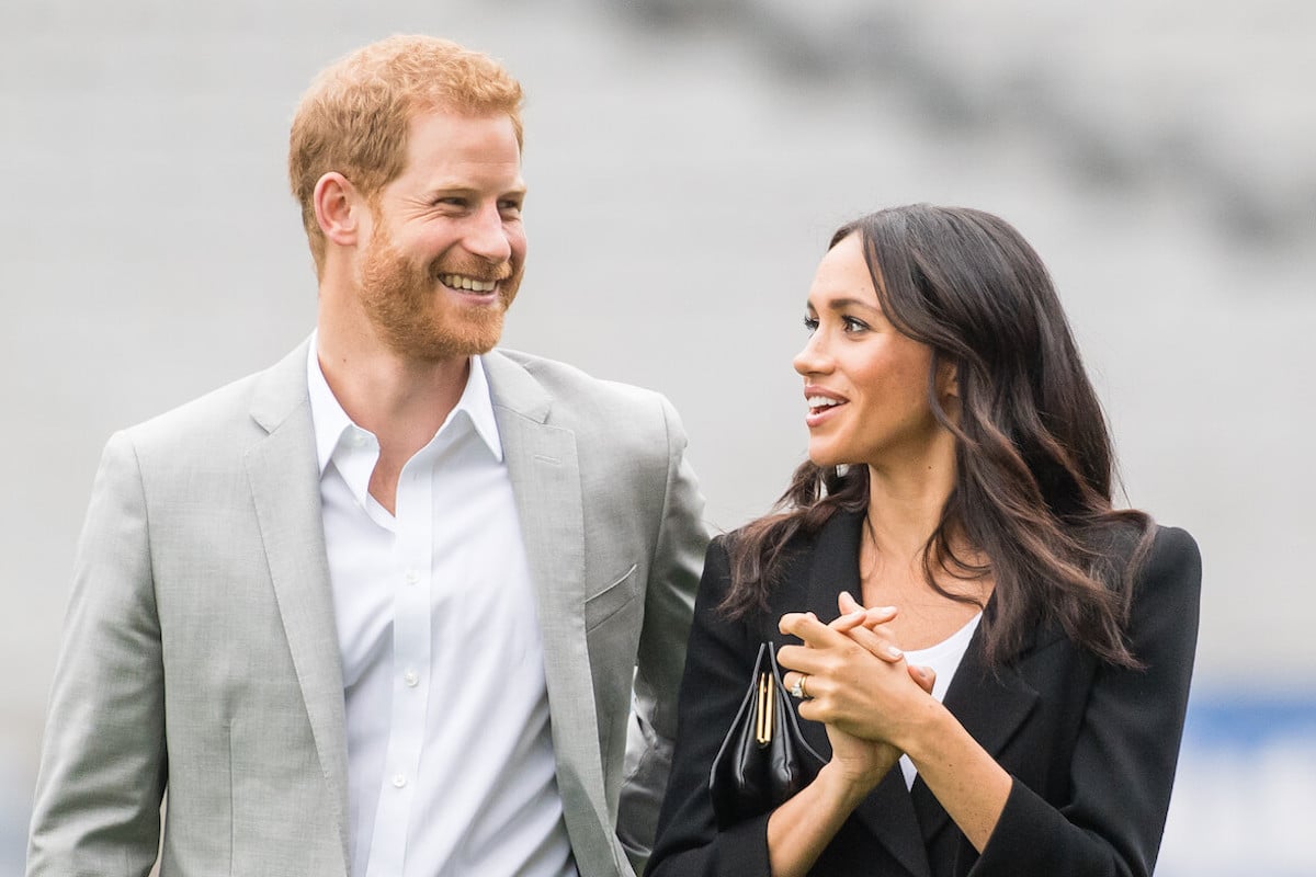 Prince Harry and Meghan Markle, who should make a positive mention about the Commonwealth while in Nigeria, per a commentator, stand next to each other in Ireland