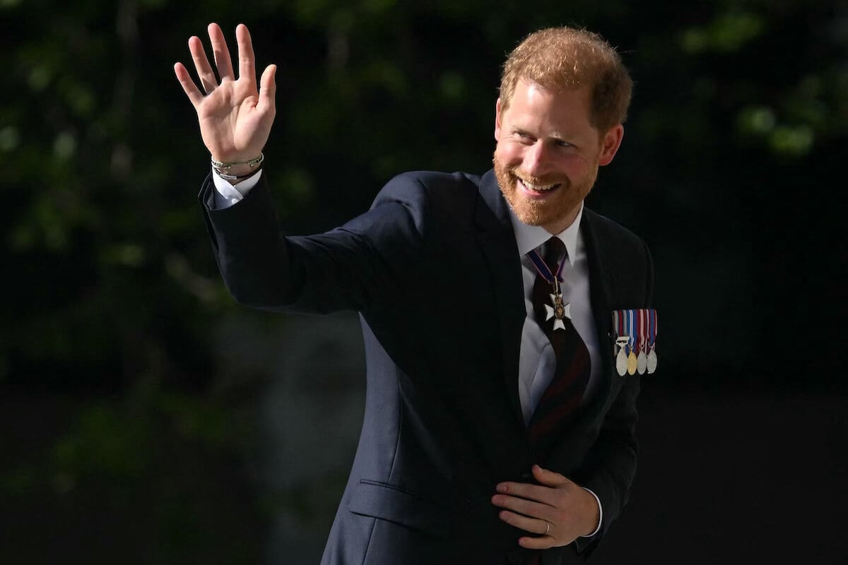 Prince Harry, whose Invictus Games anniversary service body language showed anxiety and cheekiness, per an expert, waves and smiles outside St. Paul's Cathedral