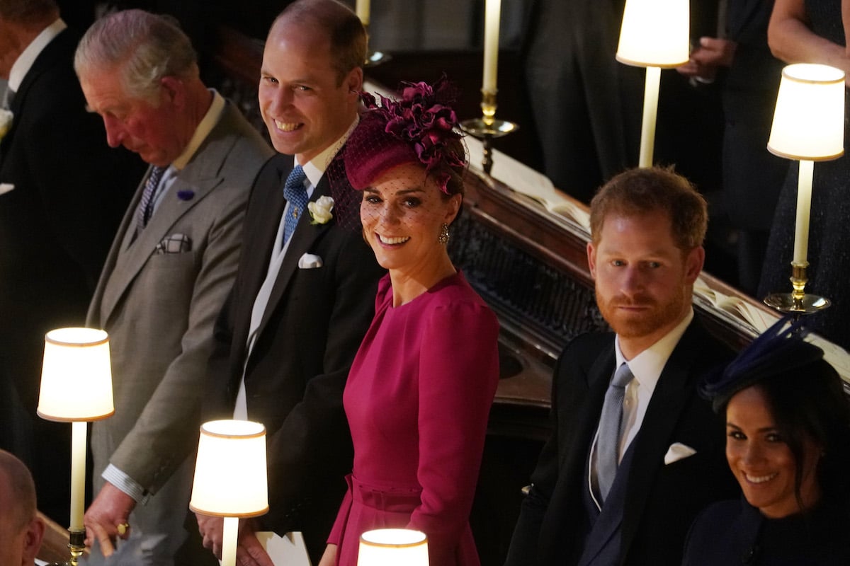 Prince William, whose reportedly preventing a Prince Harry, King Charles reunion, with King Charles, Kate Middleton, Prince Harry, and Meghan Markle standing in the pews at Princess Eugenie's wedding in 2018
