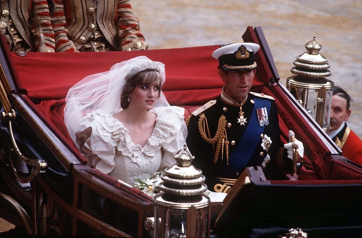 Princess Diana and then-Prince Charles ride in a carriage from St. Paul's Cathedral to Buckingham Palace following their wedding