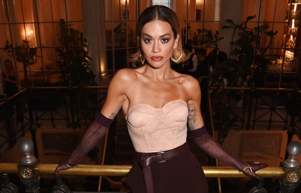 Singer Rita Ora leans against a railing at her TYPEBEA launch party