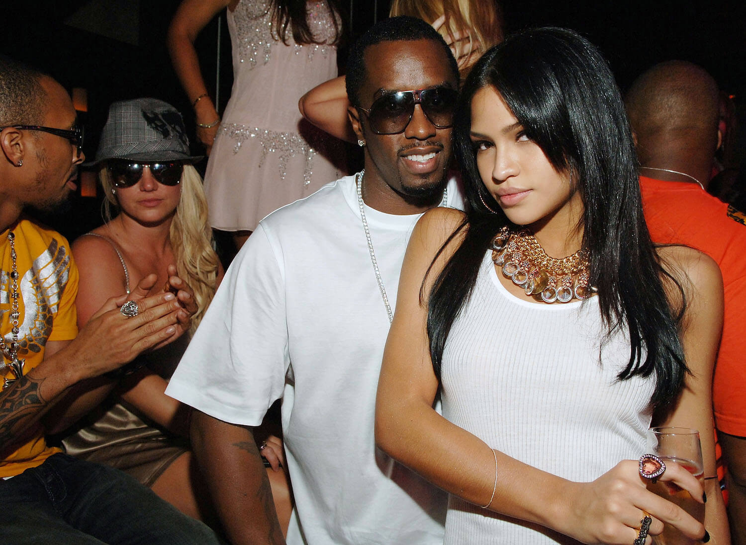 Sean 'P. Diddy' Combs and Casandra 'Cassie' Ventura posing together in front of Britney Spears and others