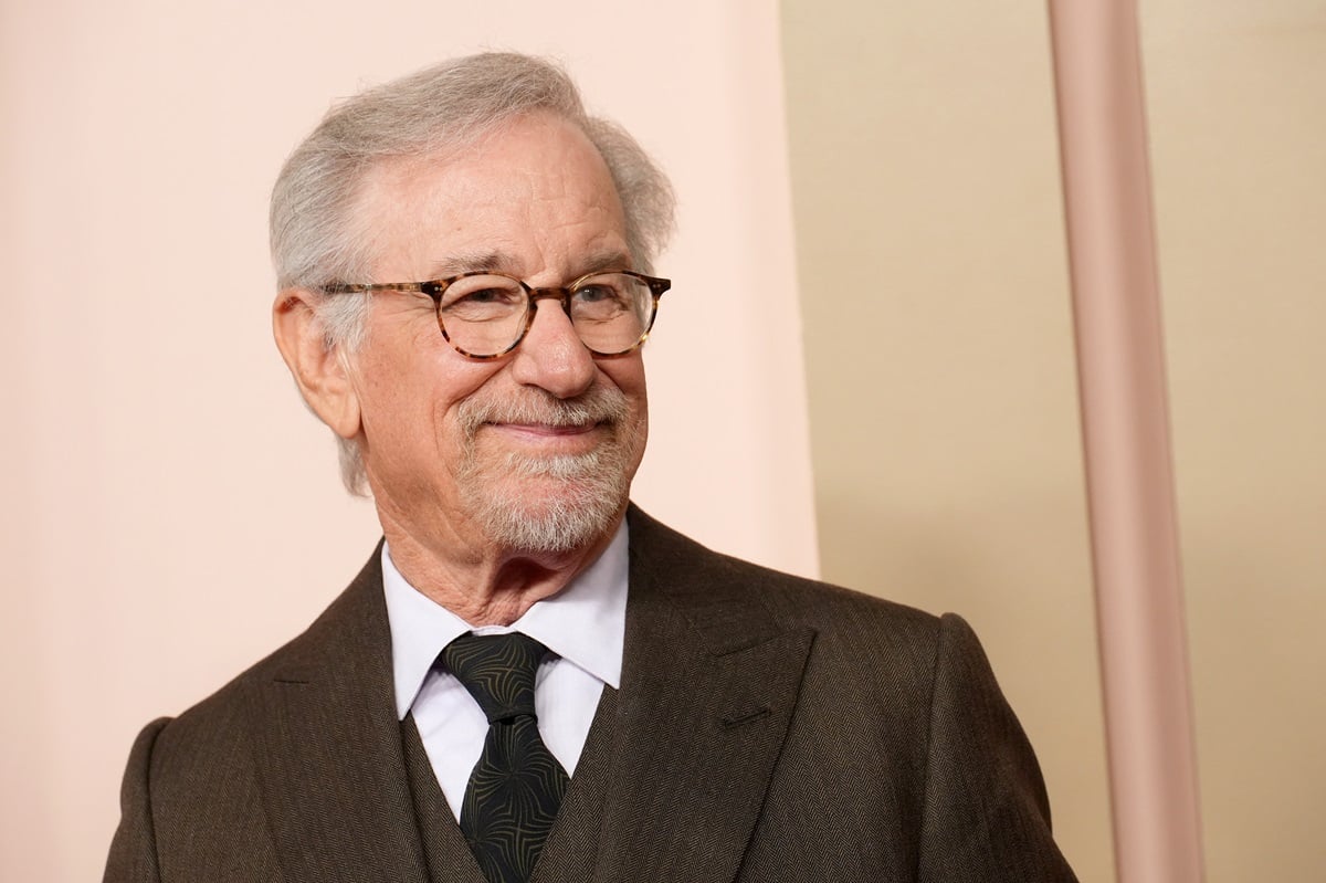 Steven Spielberg posing in a brown suit at the 96th Oscars Nominees Luncheon.