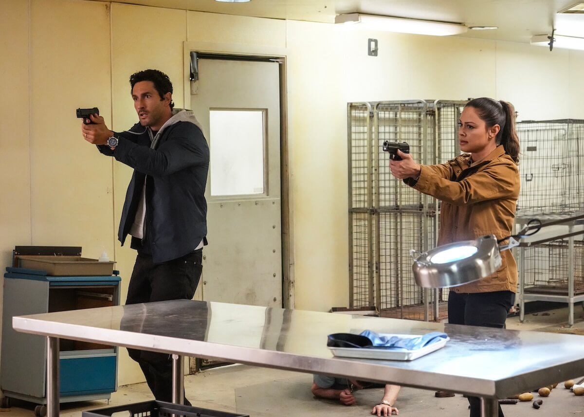 Jesse Boone and Jane Tennant with guns drawn in the 'NCIS: Hawai'i' series finale
